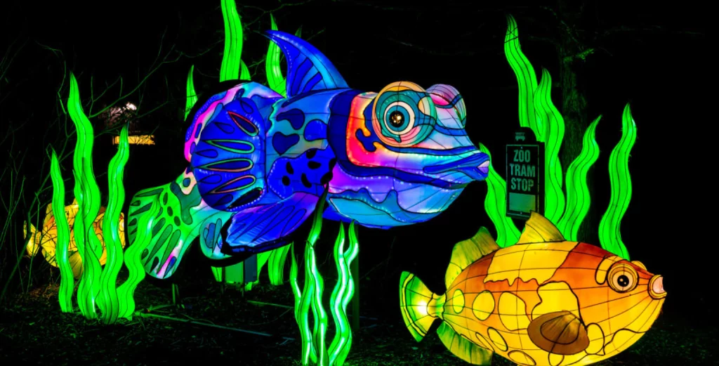 Families enjoying holiday light displays at Bright Nights at Four Mile, Denver