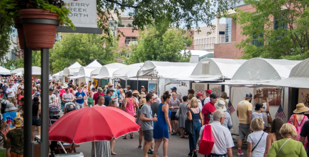 Visitors exploring art displays at the Cherry Creek Arts Festival in Denver