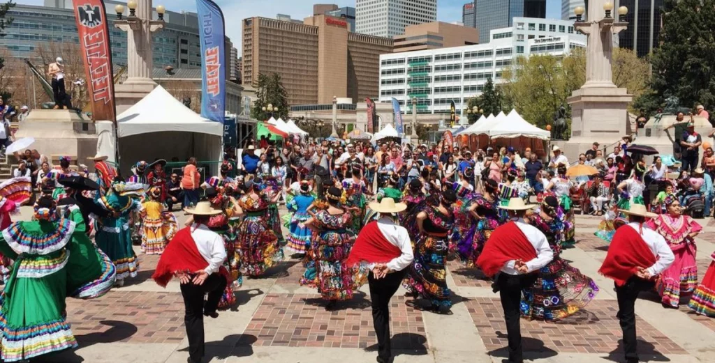 Attendees enjoying music, dance, and food at the Cinco de Mayo Festival in Denver