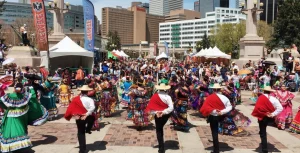 Attendees enjoying music, dance, and food at the Cinco de Mayo Festival in Denver