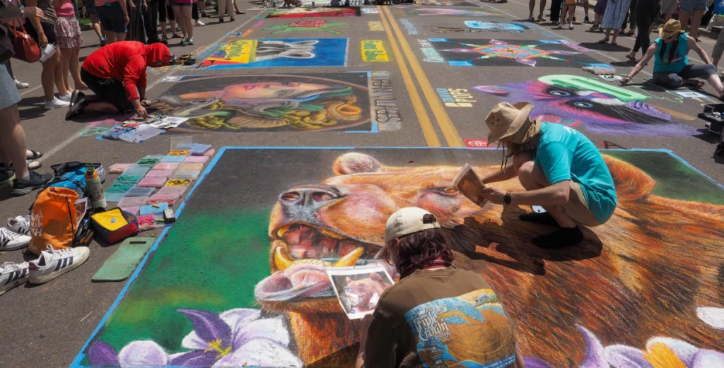Artists and visitors enjoying the Denver Chalk Art Festival in Downtown Denver